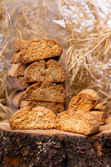 crispy rusk or toast on a dry straw background, closeup