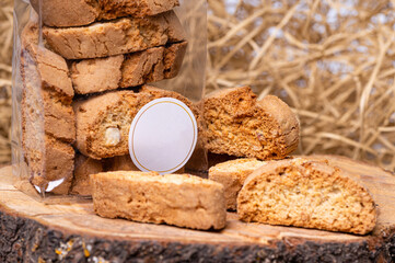 crispy rusk or toast on a dry straw background, closeup