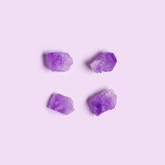 Square pattern of purple amethyst crystals on very peri color background,  top view natural...
