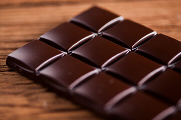 Chocolate bar, candy sweet, dessert food on wooden background