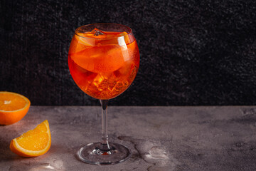 Glass of cold Aperol spritz cocktail.