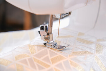 A man sews clothes on a sewing machine. Hobbies, needlework, creativity.