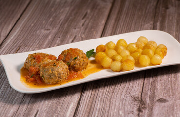 Recipe for meatballs in tomato sauce with hazelnut potatoes. High quality photo