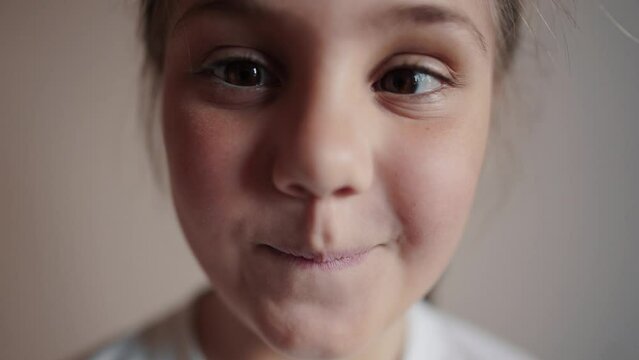 child girl playing funny a squinting eyes. strabismus squint happy family kid dream concept. daughter little girl having fun smiling twisting her lifestyle eyes funny content