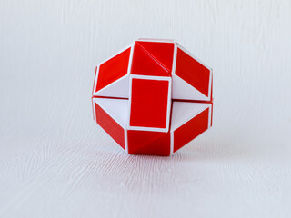 red and white bicolor magic snake Transformable twist puzzle in shape of ball isolated on white...