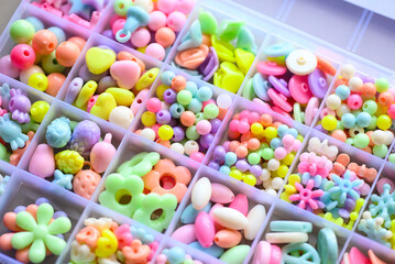 Various Bracelets colorful plastic beads made Cartoon style hand made in box. Variety of shapes and colors to make a bead necklace or a string of beads for women, diy concept