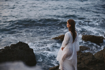 Woman in white dress nature summer stone cliff coast lifestyle unaltered