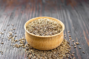 Cumin seeds in bowl on board