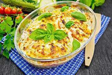 Zucchini baked with tomatoes in pan on board