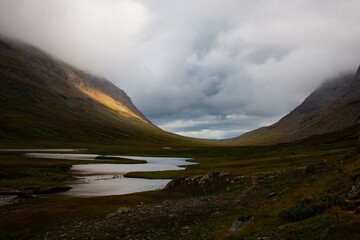 Kungsleden trail passing through U-valley near Viterskalet, the stage of the trail between Hemavan and Ammarnas on a rainy day in August, Lapland, Sweden