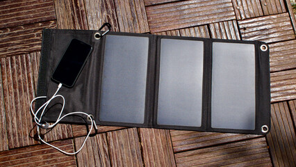 Charging mobile phone with solar energy. Phone charging using solar panels.