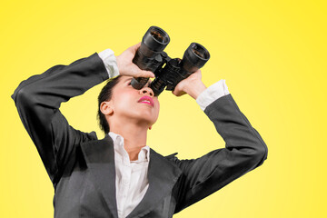 Female manager using binoculars on studio