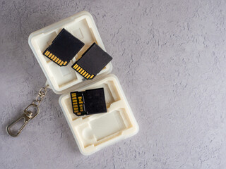 close up of an open  white extruded plastic  memory card case with soft moulded insert for SD and CFexpress cards with key chain