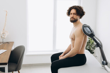 A sport man in a massage clinic where warms his muscles. New massage technologies 