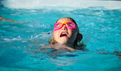 young girl in swimming pool with her head just above water learning to swim , concept of danger of...