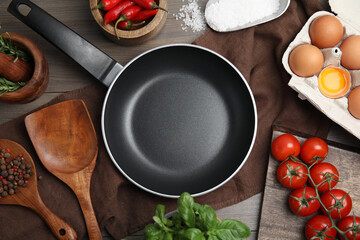 Flat lay composition with cooking utensils, frying pan and fresh ingredients on wooden table - obrazy, fototapety, plakaty