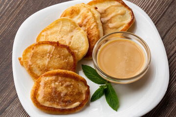 Pile of freshly fried thick pancakes, in Eastern European cuisines called oladky or oladyi with...