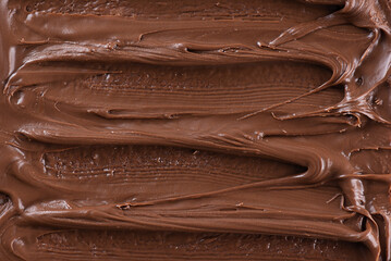 Background of smears of chocolate and hazelnut paste, top view.