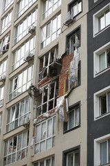 Damaged building facade after heavy artillery shooting and shelling