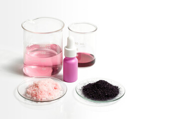Potassium Permanganate Liquid, Serum bottle with dropper, KMnO4 and Pink flake chemicals in Chemical Watch Glass. Cosmetic chemicals ingredient on white laboratory table.