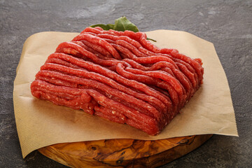 Raw beef minced meat over board