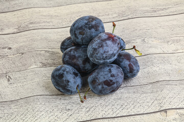 Ripe plum heap over background