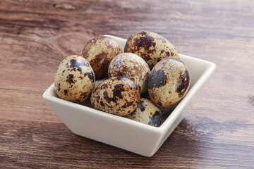 Raw quail eggs heap in the bowl
