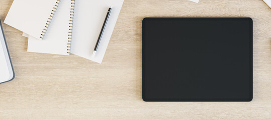 Tablet with blank screen is on top of wooden office desk table with supplies, above view. Mock up, 3D Rendering.