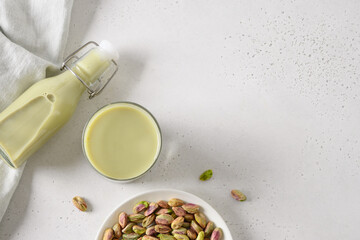 Healthy Pistachio milk on white background. Horizontal orientation. View from above. Copy space. Vegan nutty plant based milk.