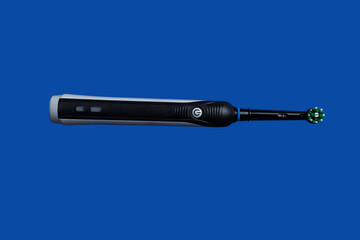 Fototapeta premium Closeup of Electric toothbrush isolated on blue background