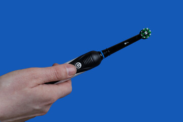 Closeup of Electric toothbrush  on blue background