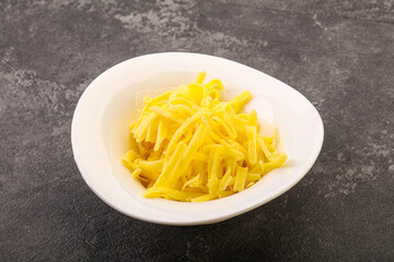 Shredded yellow cheese in the bowl