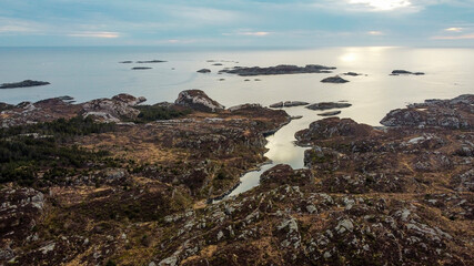 Fototapeta na wymiar Aerial view of the sea wave and rocks of the coastline of Norway, Telavåg. Panoramic view of the rocks by the sea. The sea wave rolls along the shore. View of the sea coast from the air. Ocean space