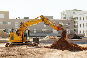 Excavator Working on Construction Site. Crawler Excavator Throws Ground on pile on Urban Place....