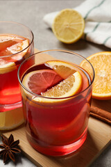 Aromatic punch drink and ingredients on light grey table