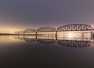 Beautiful view of the big four bridge reflected in the lake at night in Louisville Kentucky