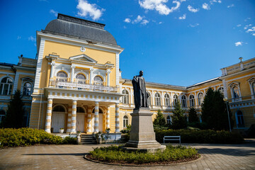 Frantiskovy Lazne, Western Bohemia, Czech Republic, 14 August 2021: Neo-Renaissance building Imperial Baths in park of great famous spa town Franzensbad, Monument to Francis Joseph I, sunny day