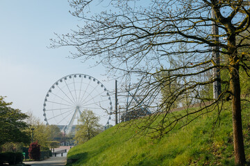 a big wheel in the summer. Ferris wheel in a green city.  amusement park in Germany