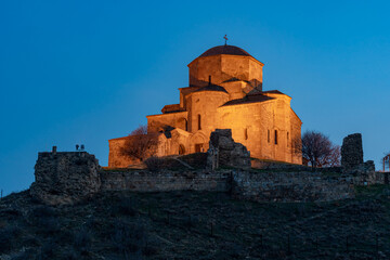 Illuminated Jvari Monastery on the top of the hill at night. Mtskheta