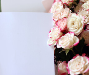 Wedding, birthday stationery mock-up scene. Blank paper greeting card, invitation. Decorative floral composition. Closeup of pink roses petals. Mock up with empty space.