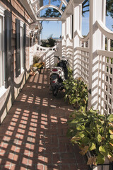 Vertical shot of sunny shadows on an alley in Lewes ,Delaware © Balashark/Wirestock Creators