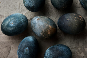 Obraz na płótnie Canvas eggs painted in the color of concrete lie on a gray background