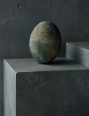 concrete color egg on a concrete cube against a concrete fusion background