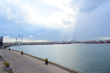 Tranquil lake with boats on the port on a bright day