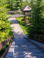 Picturesque stone path in the Carpathians. Pathway of winter ski resort Bukovel in Carpathian Mountains, Ukraine in Summer. Sights of the modern popular ski resort of Bukovel.