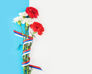 Red and white carnation with Russian flag ribbon