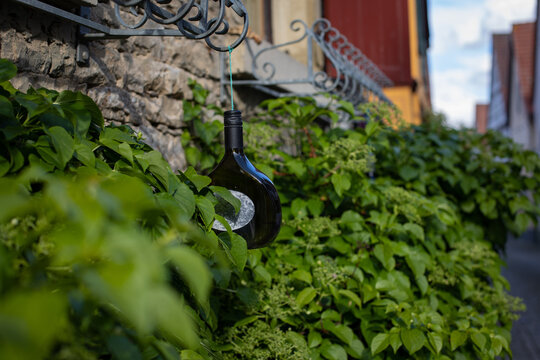 Bocksbeutel (Wine bottle ) hanging from a balcony