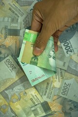 Dua puluh ribu rupiah, translate 20000 IDR, Indonesia rupiah money concept was helad by businessman...