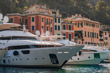Naklejka premium Liguria, Italy, Europe. Luxury yachts and boats in The beautiful Portofino with colorful houses and villas, in little bay harbor.