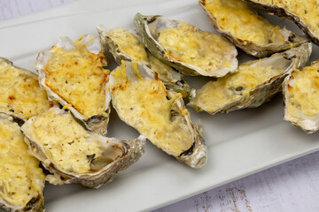 Baked oysters with cheese in a dish
